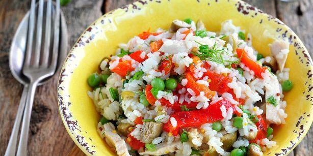 Salat mit Reis, Huhn, gebackenem Paprika, Erbsen und Oliven