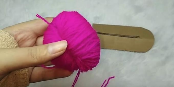 Wie man einen Pompon macht: Entfernen Sie die Fäden